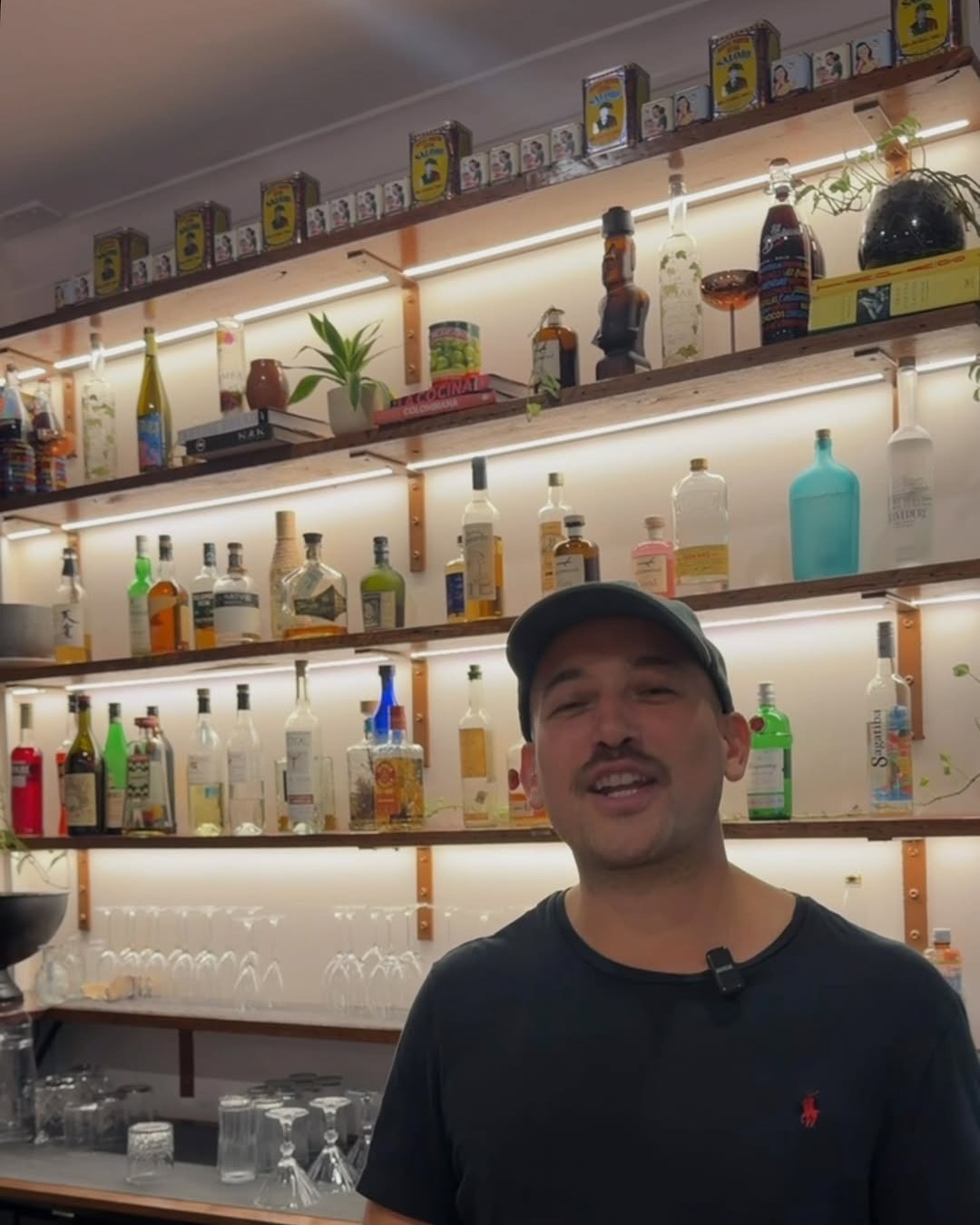 A member of the Big Papi’s team behind the back bar of spirits