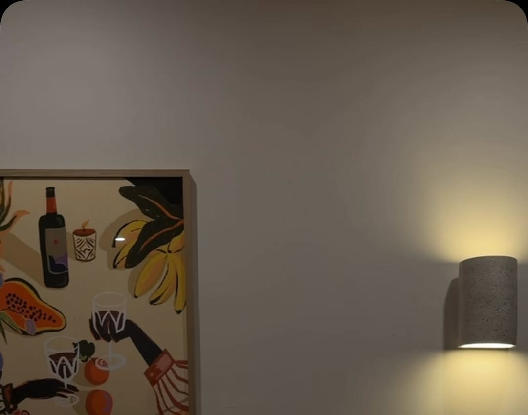 Latin still-life artwork and a wall lamp inside the dining room